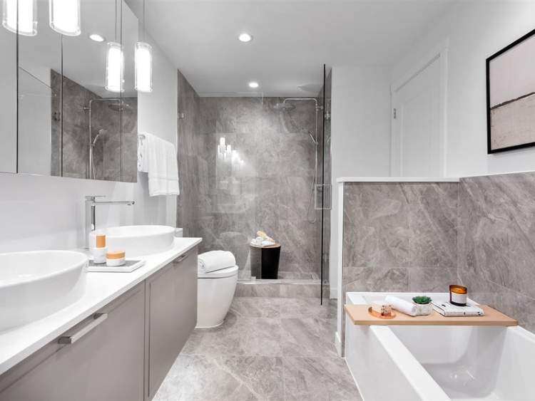 A sophisticated en suite is blanketed in tiles, and features a spacious double vanity and an invigorating shower.